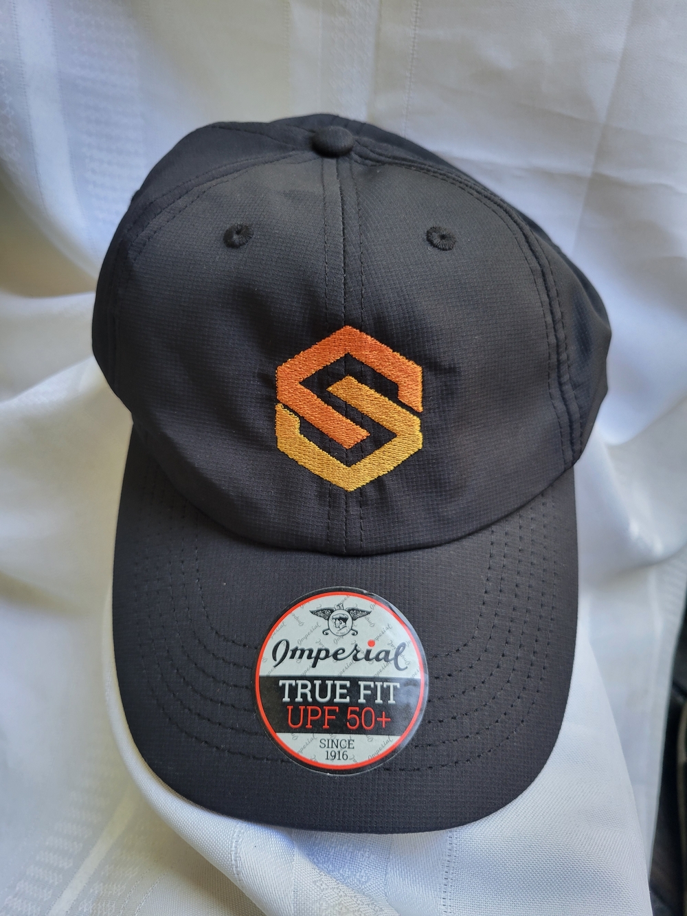 Imperial Black Baseball Cap with Orange/Yellow Embroidered Logo